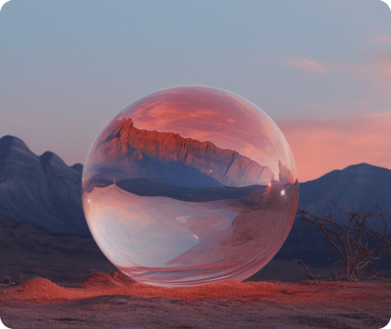 A clear sphere reflects a red mountain landscape at sunset in a desert setting.