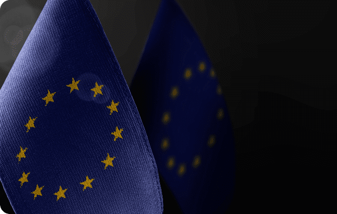 A close-up of the European Union flag, with its characteristic blue background and a circle of twelve yellow stars.